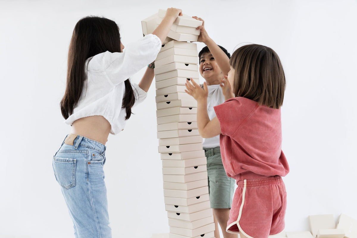 children's day celebration launch with kids stacking boxes joyfully