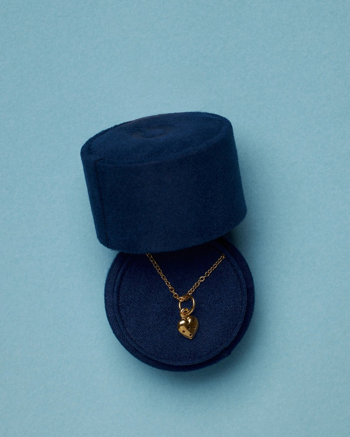 Gold heart pendant necklace in elegant jewelry box, featured in a timeless jewelry guide.