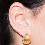 model wearing maxi tilly earrings in gold