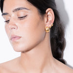 model wearing maxi tilly earrings and tilly earrings in gold