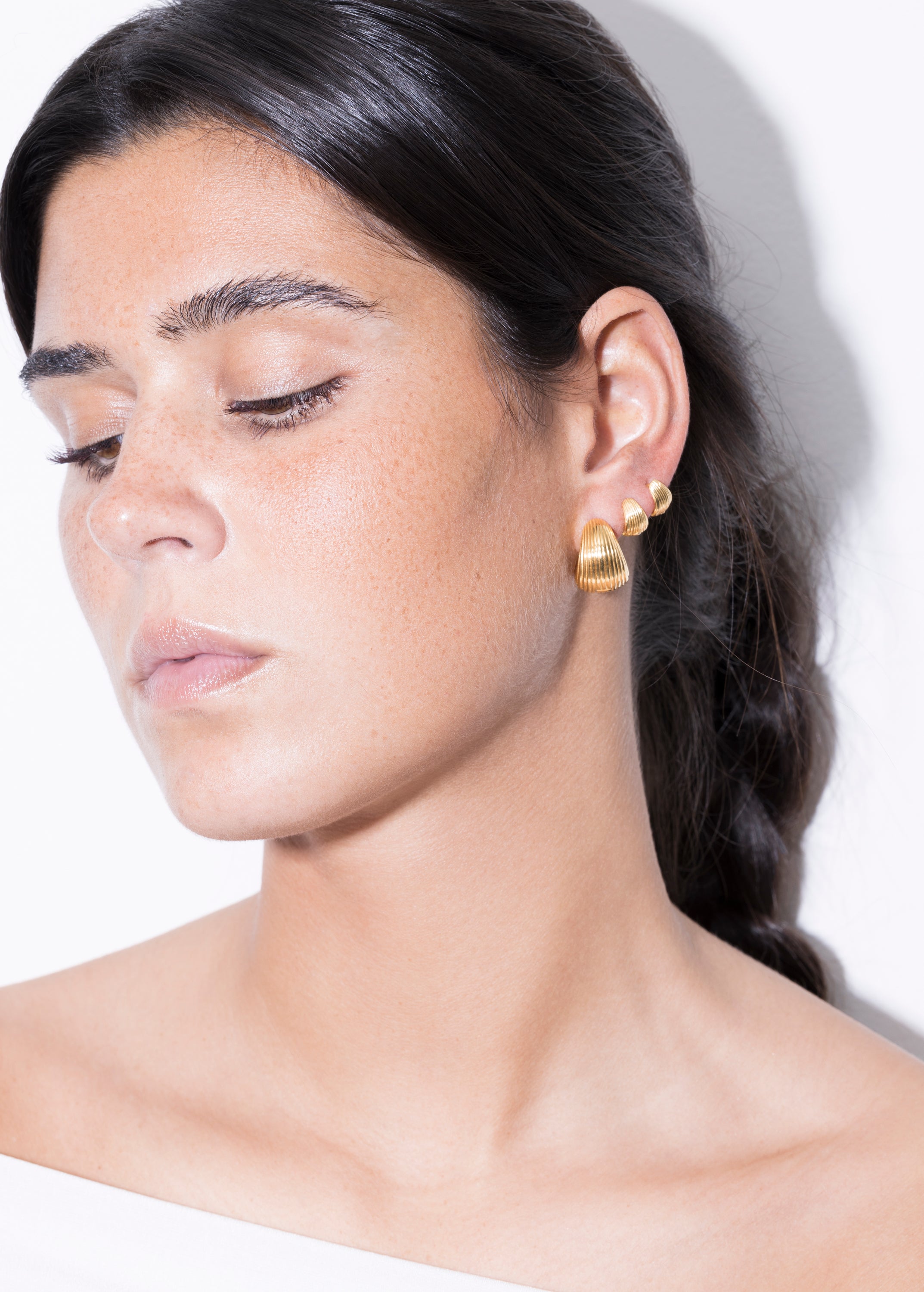 model wearing maxi tilly earrings and tilly earrings in gold