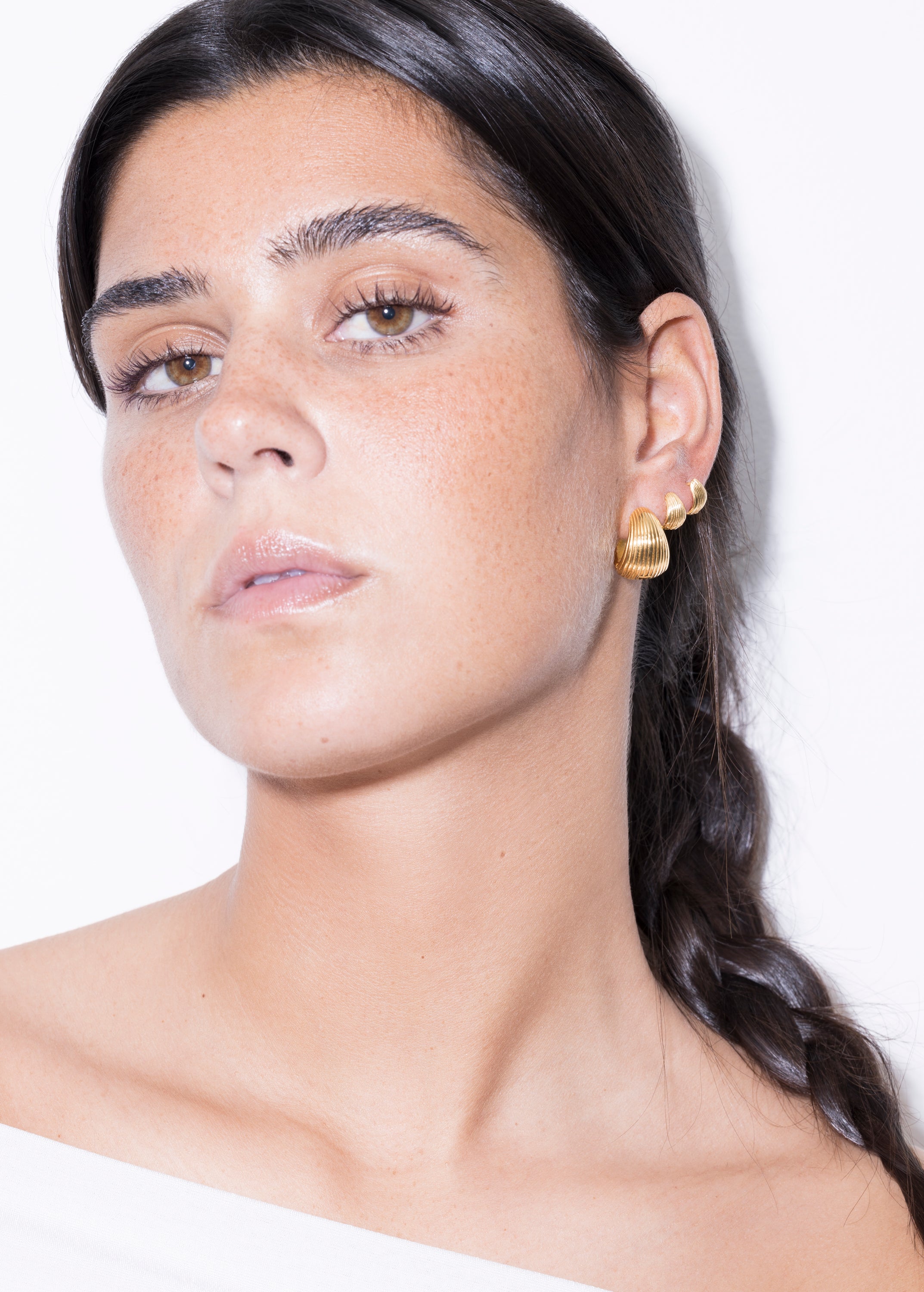 model wearing maxi tilly earrings and tilly earrings in gold