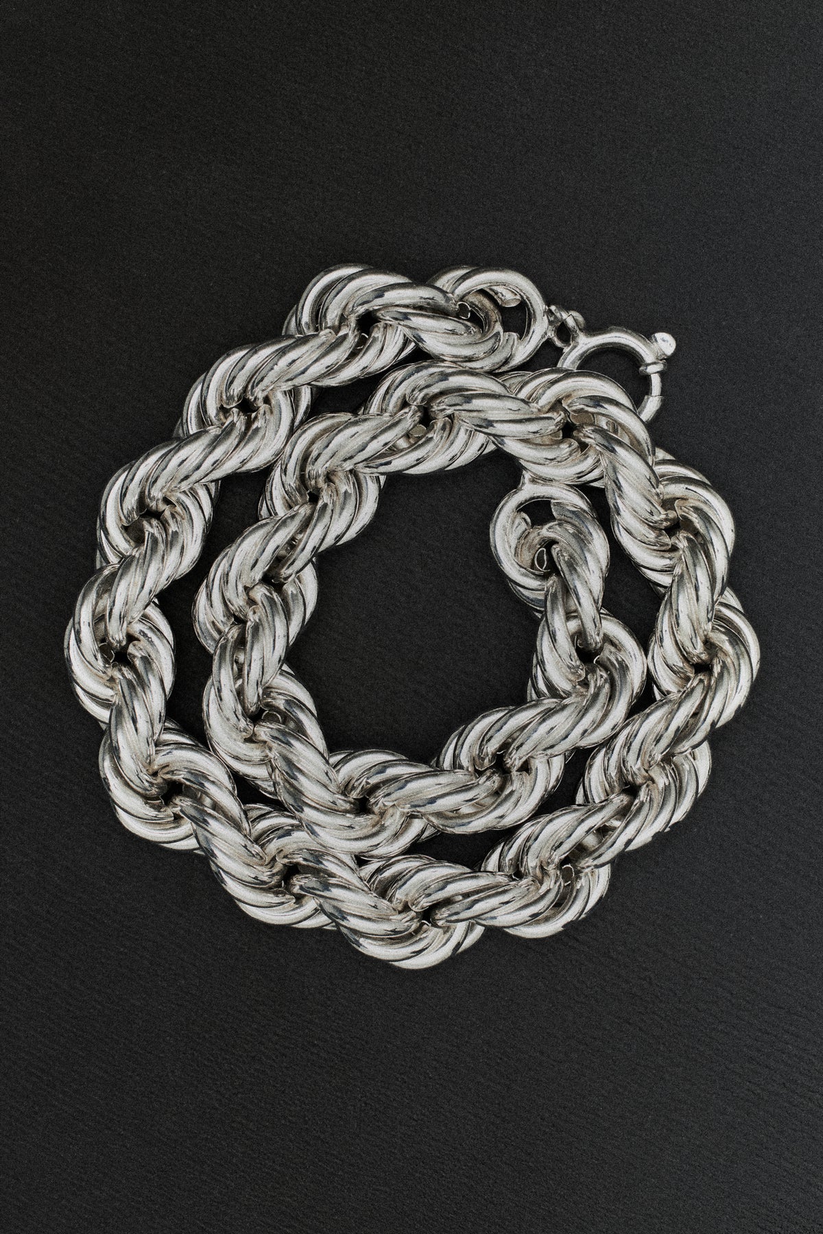 Silver chain necklace on a black background