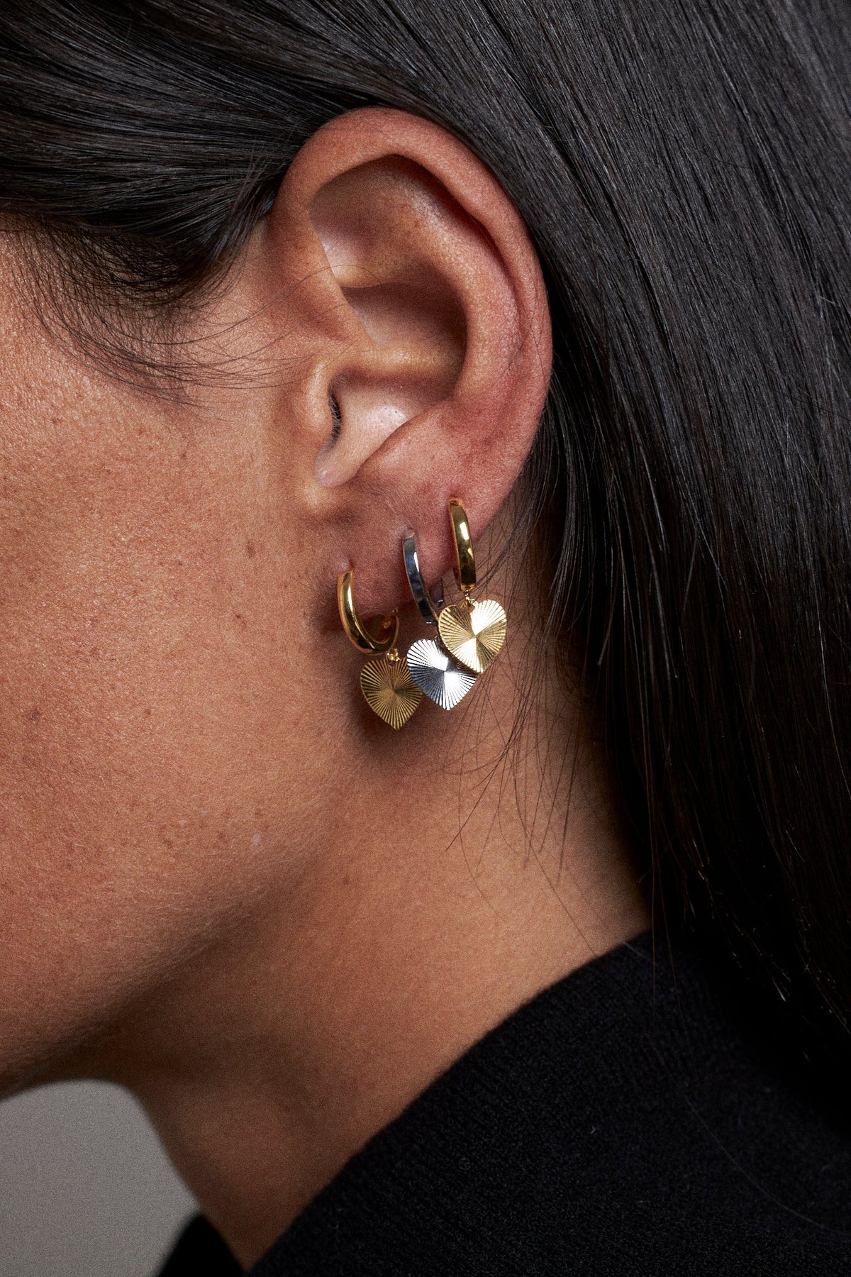 Elegant heart-shaped earrings for modern ear stack in second hole earring guide.