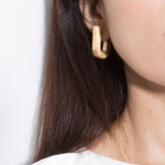 model wearing fiona brushed earrings in gold