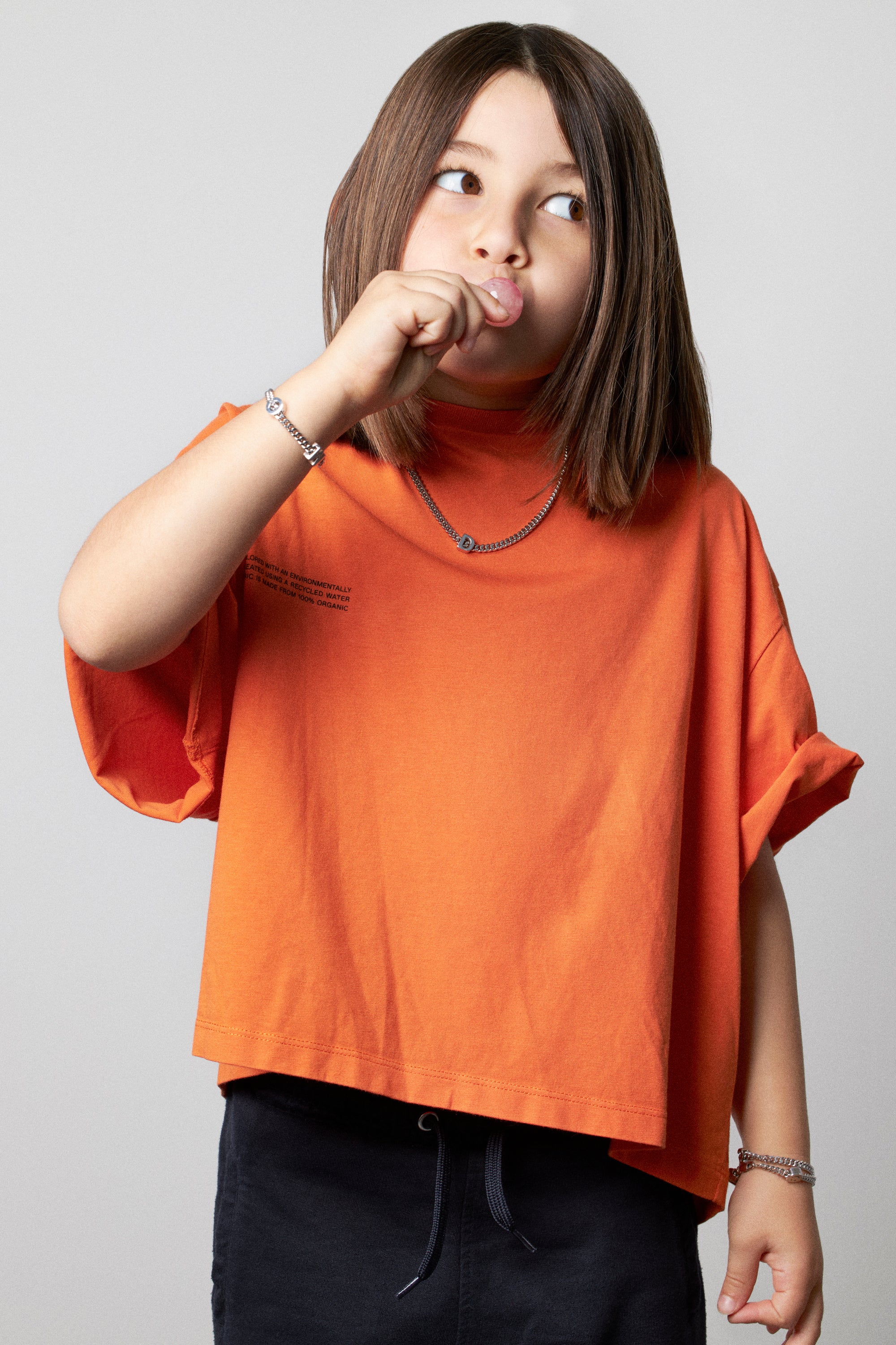 model wearing necklace alphabet with letter D in silver and kids bracelet with letter M and C in silver