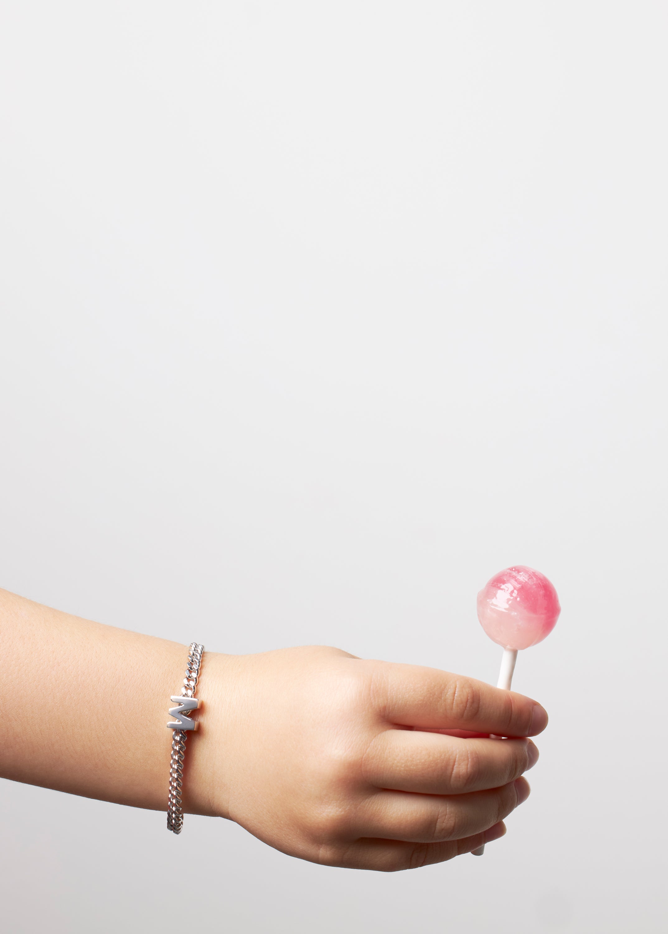 model wearing kids bracelet with letter M in silver