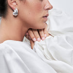 model wearing sia earrings in silver