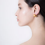 model wearing alma earrings in gold