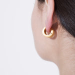 model wearing alma earrings in gold