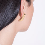 model wearing almost fiona earrings in gold