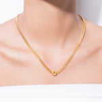 model wearing alphabet necklace with pendant Q in gold