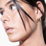 model wearing amina double layer earrings in gold