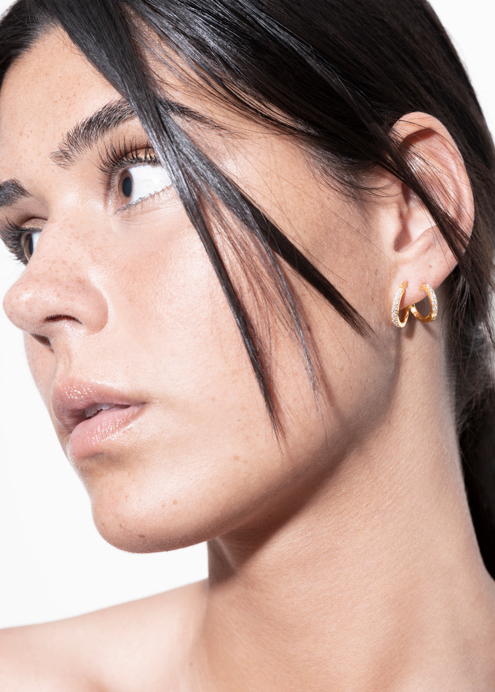 model wearing amina double layer earrings in gold