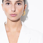 model wearing bia earrings and mini bia earrings in gold