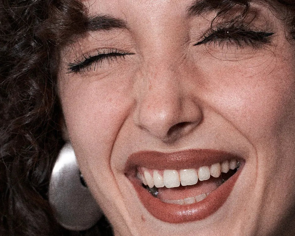 Close-up of a woman's face with a warm and inviting expression.