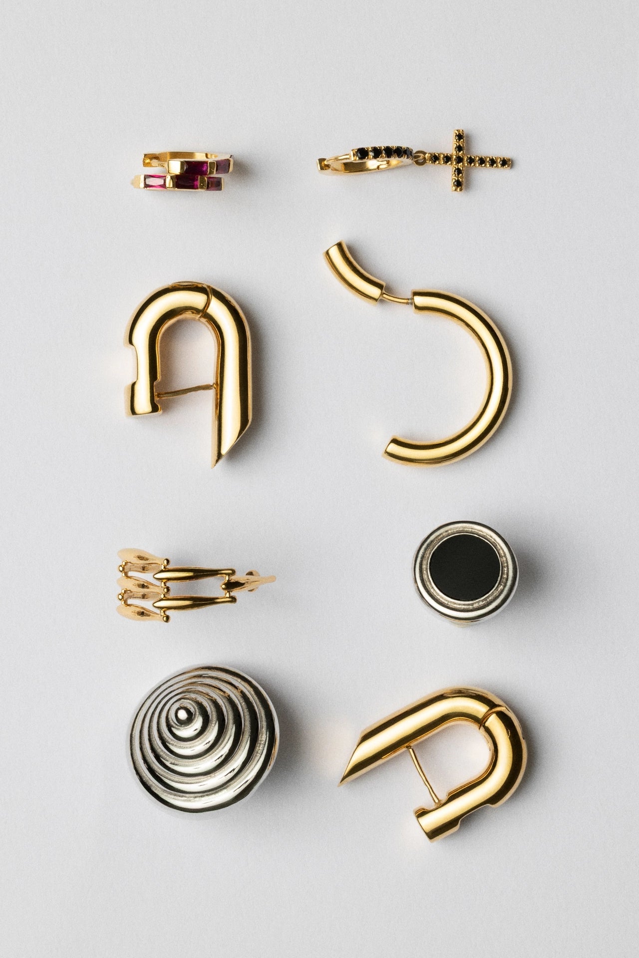 Collection of various gold and silver earrings on a light gray background CINCO archive jewelry collection - exclusive limited edition pieces at special prices