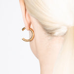 model wearing cat earrings in gold