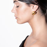 model wearing daphne earrings in gold