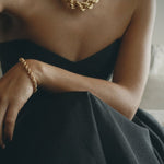 model wearing goliath bia necklace and bia bracelet in gold