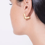 model wearing eliza earrings in gold