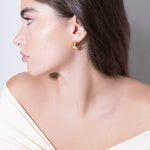 model wearing gina earrings in gold