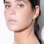 model wearing maxi jodie earrings in gold