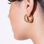 model wearing maxi jodie earrings in gold