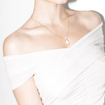 model wearing klein necklace in gold