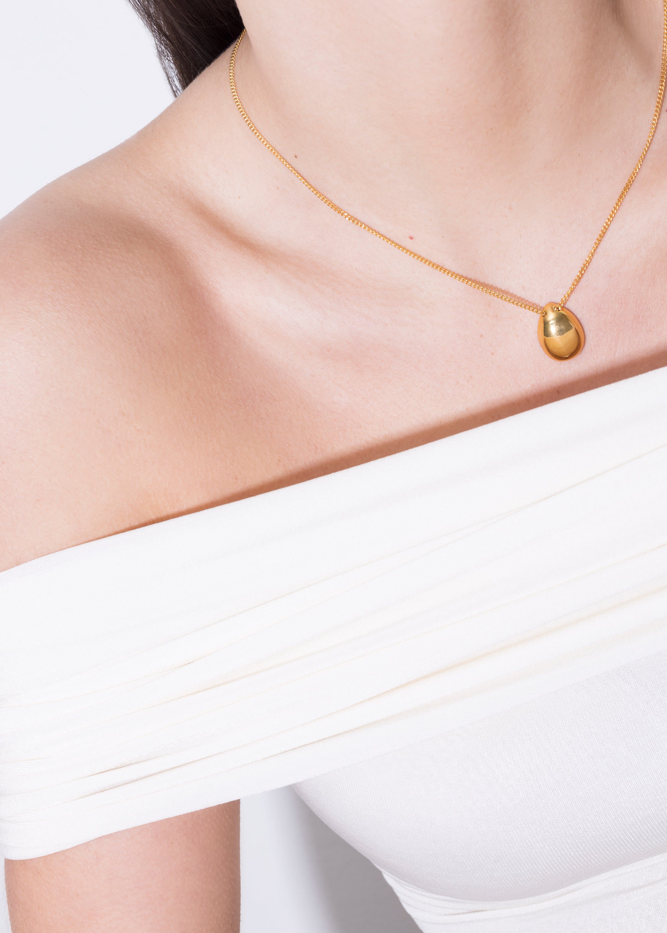 model wearing klein necklace in gold