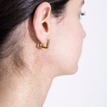 model wearing lizzie earrings in gold