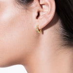 model wearing norma earrings emerald in gold