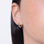 model wearing norma earrings emerald in gold