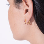 model wearing norma earrings rubi in gold