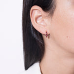 model wearing norma earrings rubi in gold