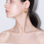 model wearing pamela earrings in gold