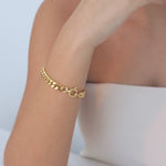 video of model wearing huda bracelet in gold