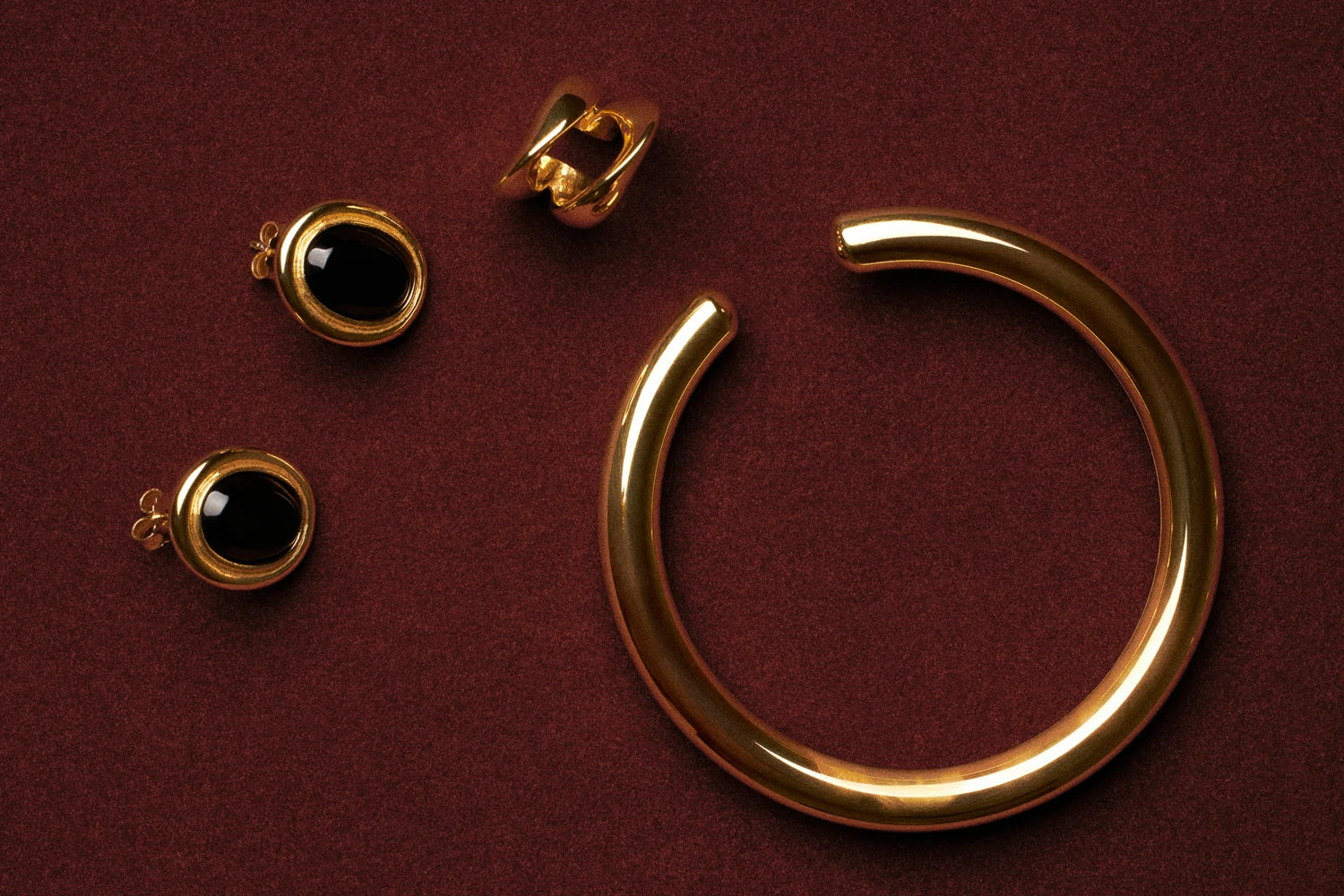 Gold jewelry on a red background