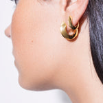 model wearing sarah polished huggies and mini sarah polished in gold