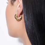 model wearing sarah polished huggies in gold