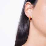 model wearing sarah polished huggies in gold