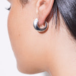 model wearing sarah polished huggies in silver