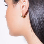 model wearing mini sarah polished earrings in gold