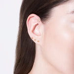 model wearing smile 18k diamond earring and the original piercing 18k 