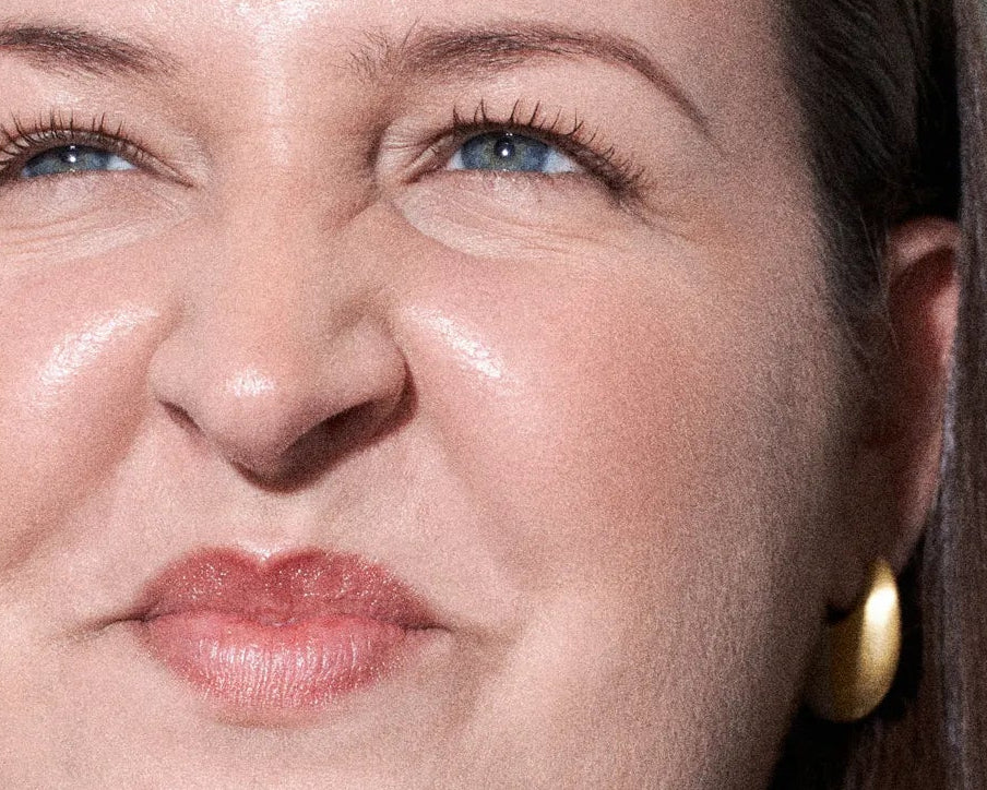 Close-up of a woman's face with a gold earring.