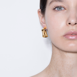 model wearing tina wrapped earrings in gold