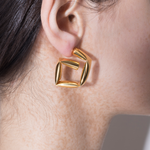 model wearing tina wrapped earrings in gold