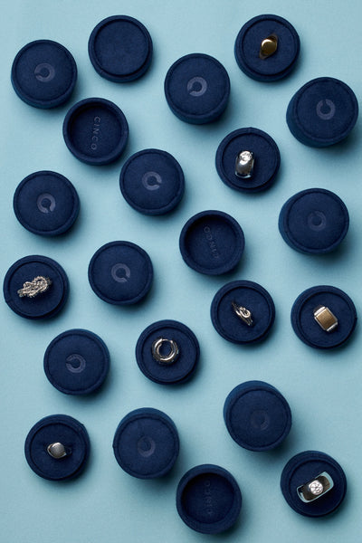 Tiny velvet jewelry box for travel displaying various jewelry pieces in blue velvet.