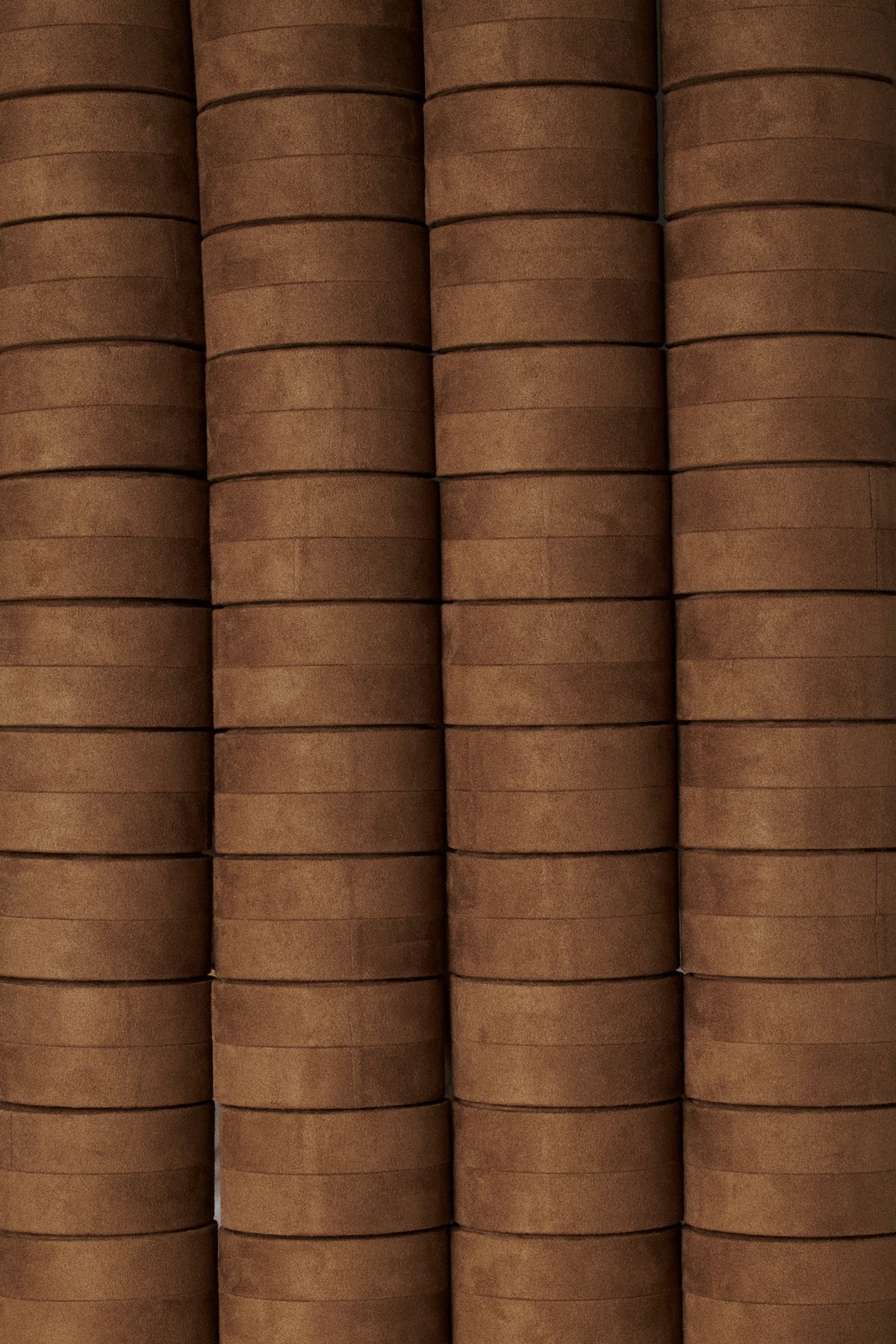 Medium Velvet Jewelry Box in rich brown color arranged in a stacked pattern showcasing its smooth texture.