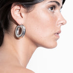 model wearing violet earrings in silver